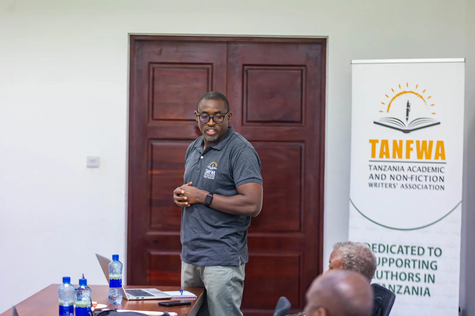 A TANFWA presenter leading a seminar beside the TANFWA banner